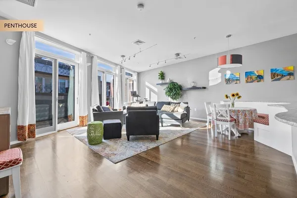 a living room with furniture and a wooden floor