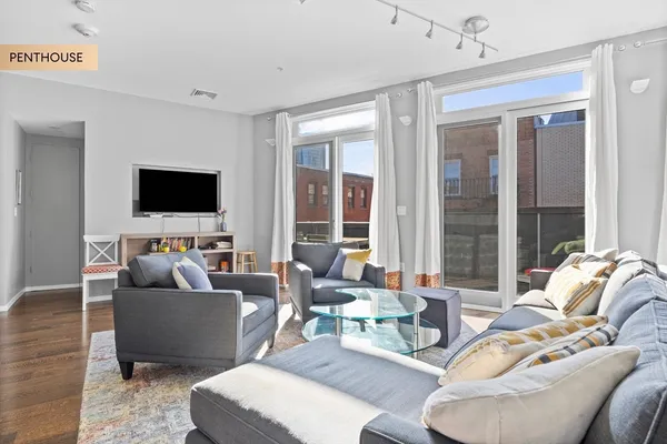 a living room with furniture and a flat screen tv