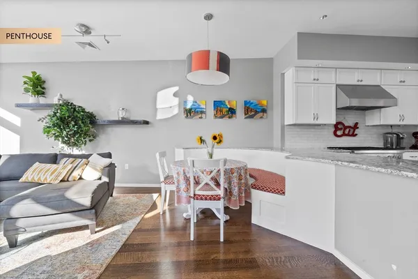 a dining room with furniture and a wooden floor