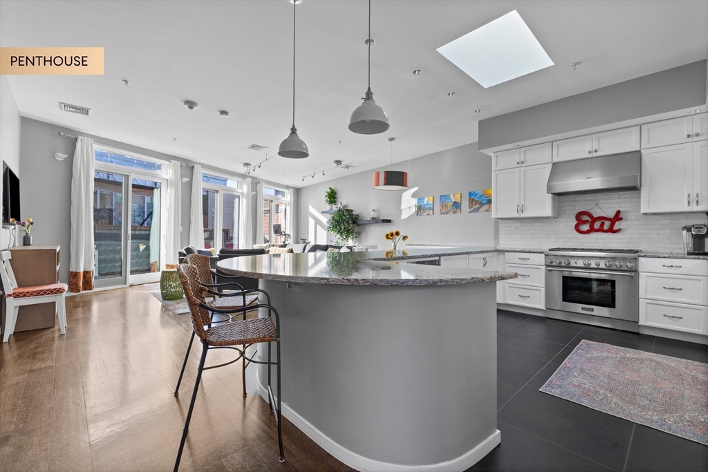133 Salem Street Boston, MA 02113 - Photo 7 of 27 a kitchen with stainless steel appliances granite countertop a sink a stove a dining table and chairs