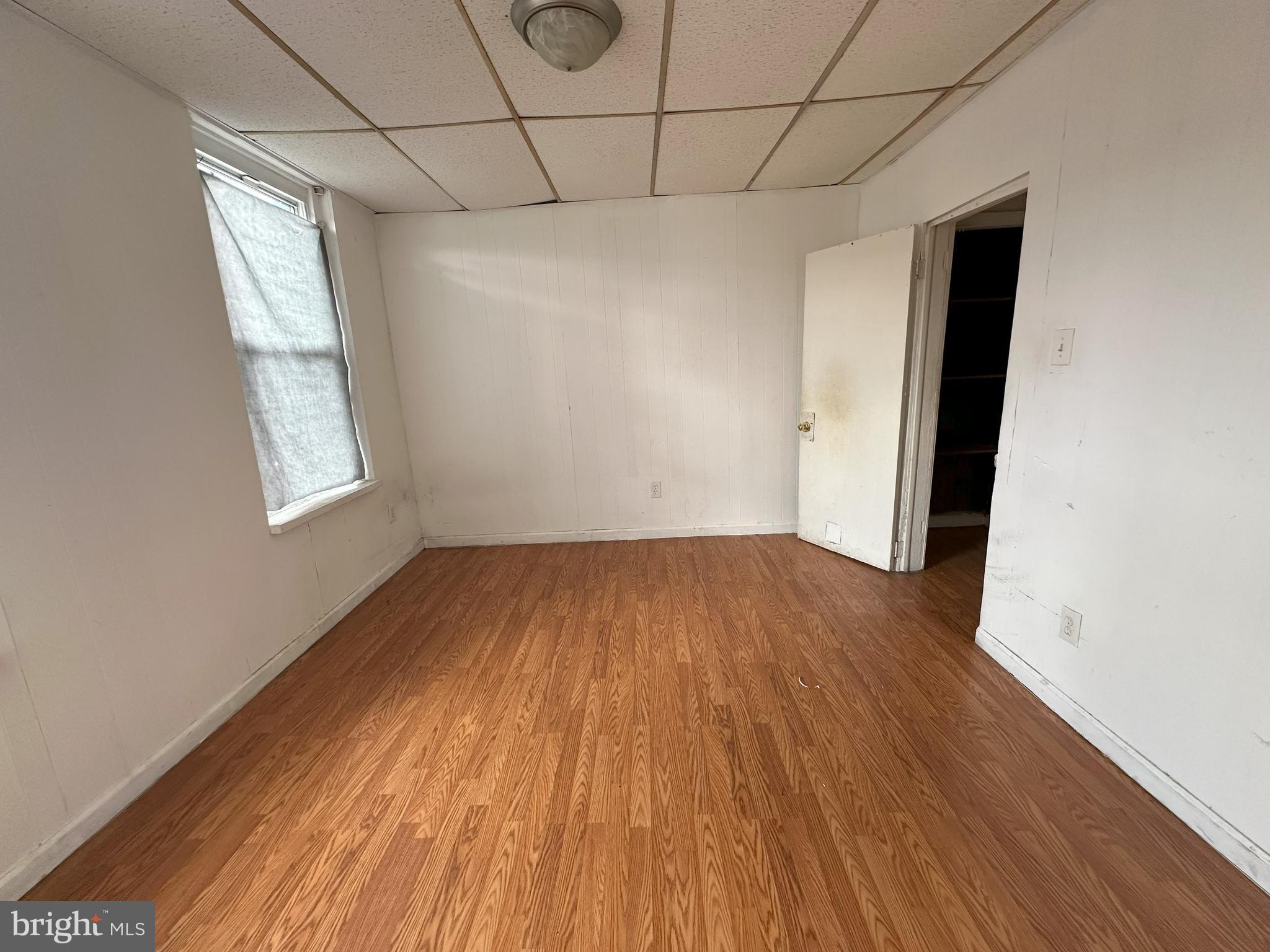 2539 South Marshall Street Philadelphia, PA 19148 - Photo 9 of 13 an empty room with wooden floor and windows
