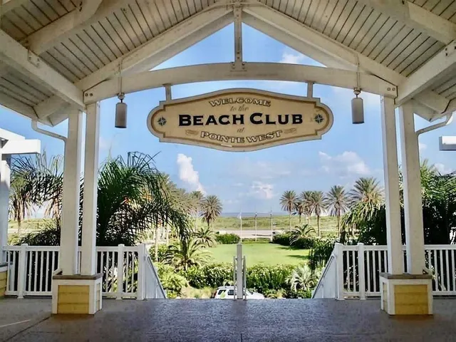 a front view of multi story residential apartment building with yellow lighting