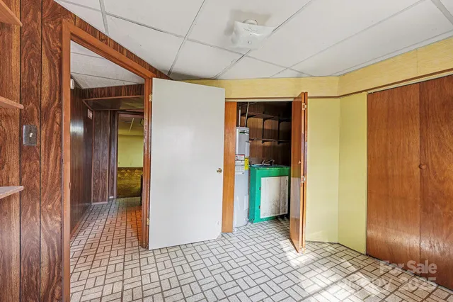 a view of a hallway with wooden walls