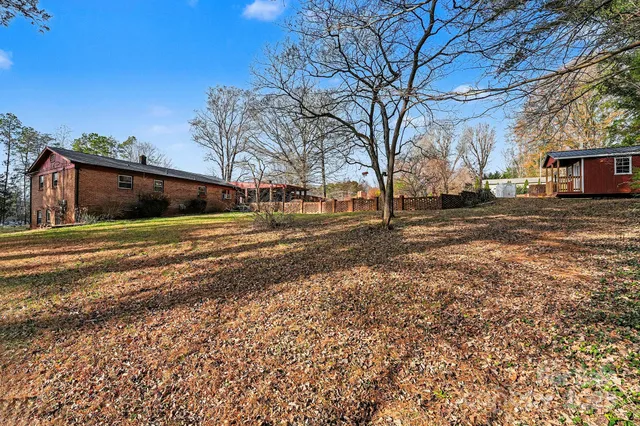 a backyard of a house with lots of green space and fountain