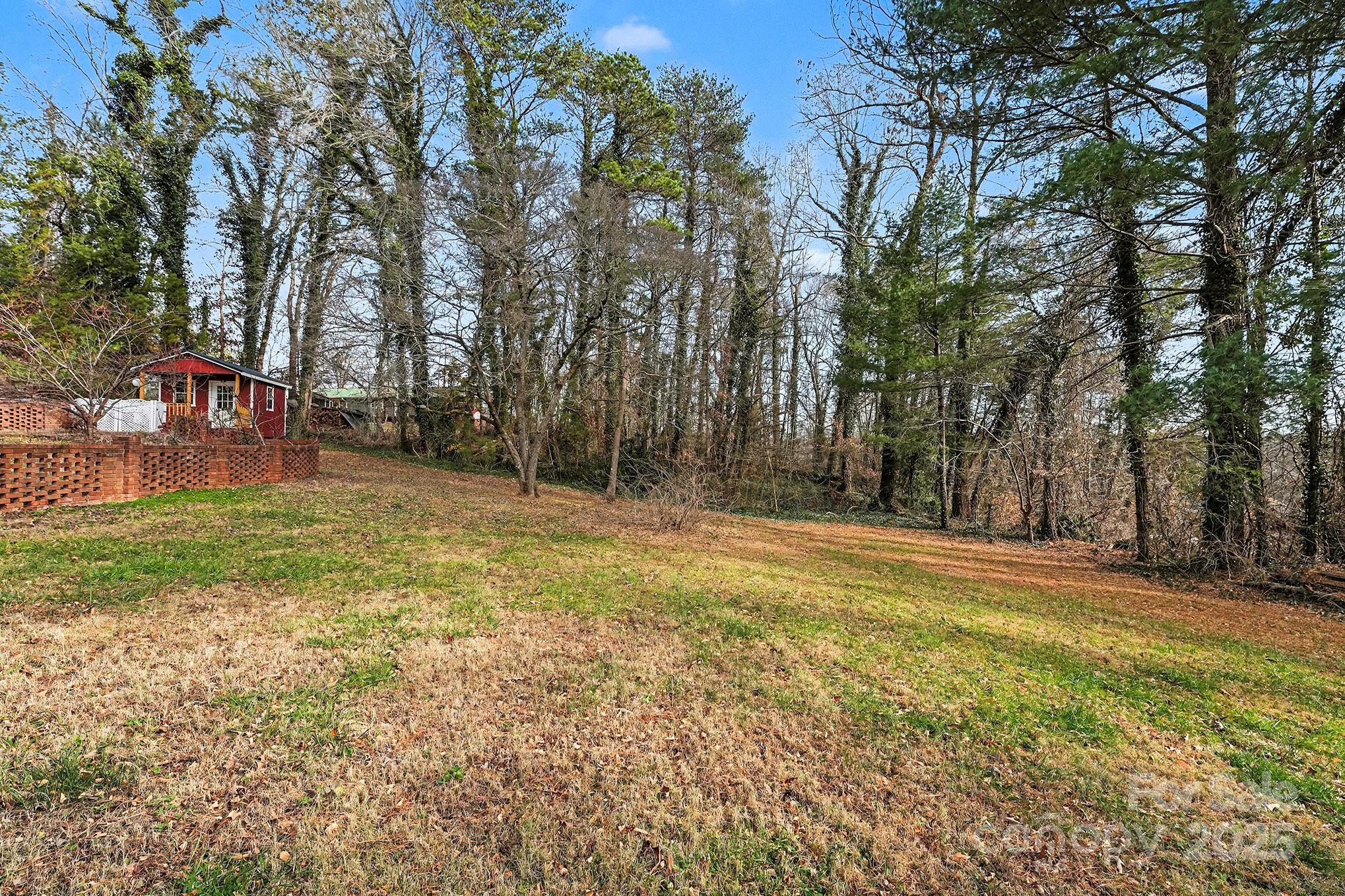 3442 Lester Street Conover, NC 28613 - Photo 36 of 38 a backyard of a house with lots of green space and fountain
