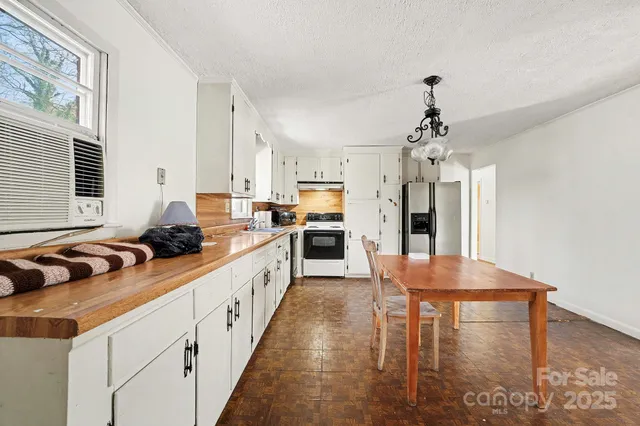 a kitchen with stainless steel appliances a refrigerator and a stove