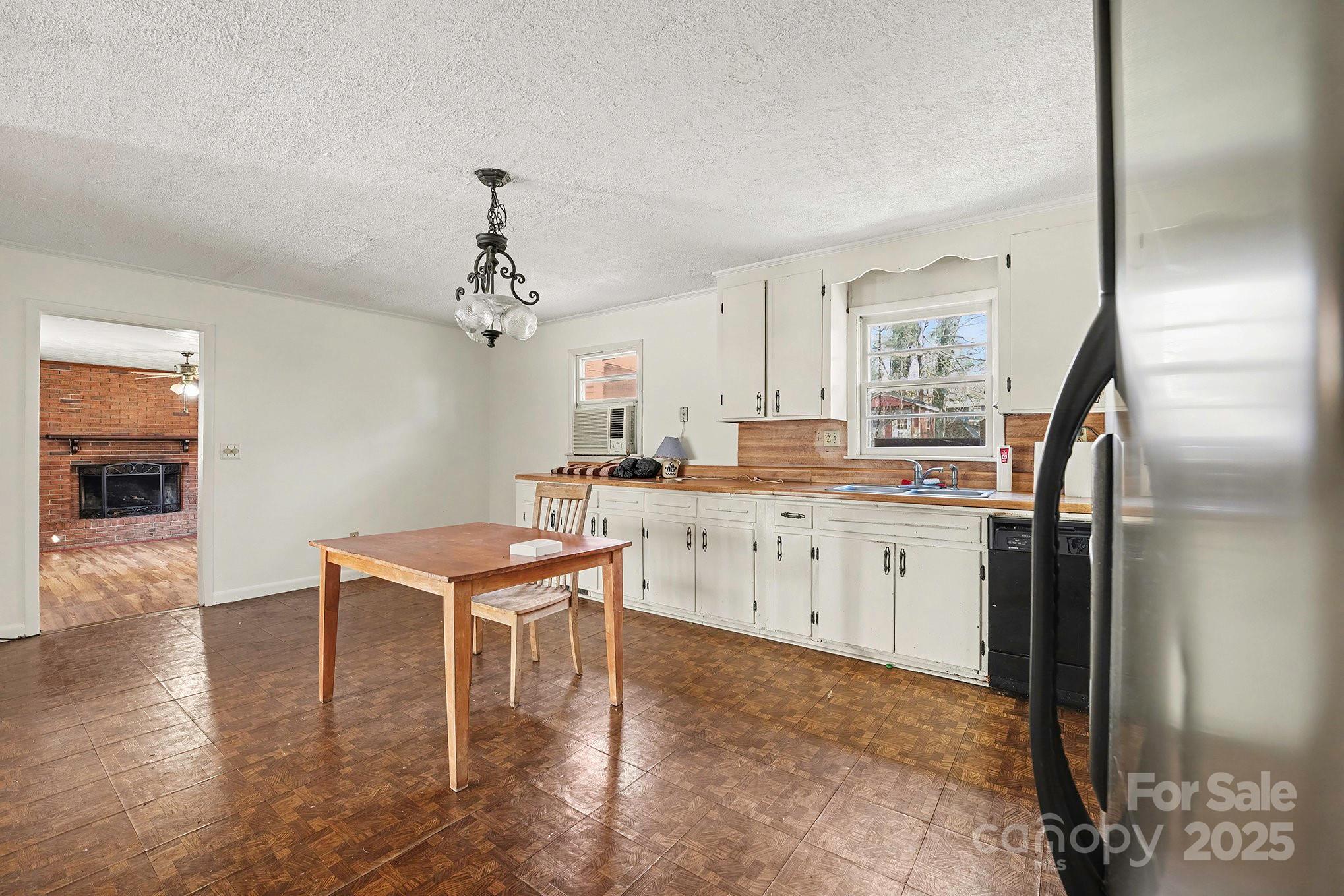 3442 Lester Street Conover, NC 28613 - Photo 10 of 38 a kitchen with stainless steel appliances granite countertop a refrigerator a sink dishwasher a stove and white cabinets with wooden floor