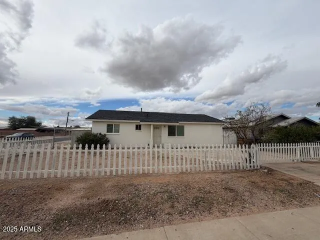 a view of a small yard with wooden fence