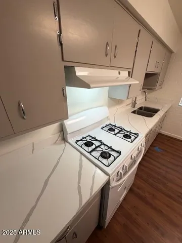 a stove top oven sitting inside of a kitchen