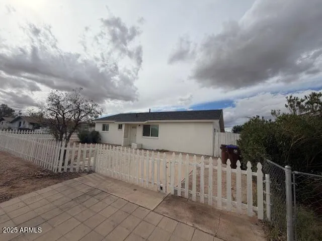 a view of a house with wooden fence
