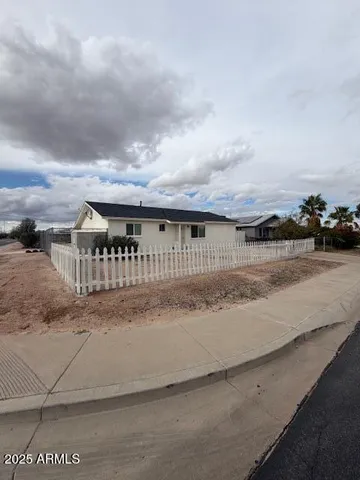 a view of house with outdoor space and sitting yard