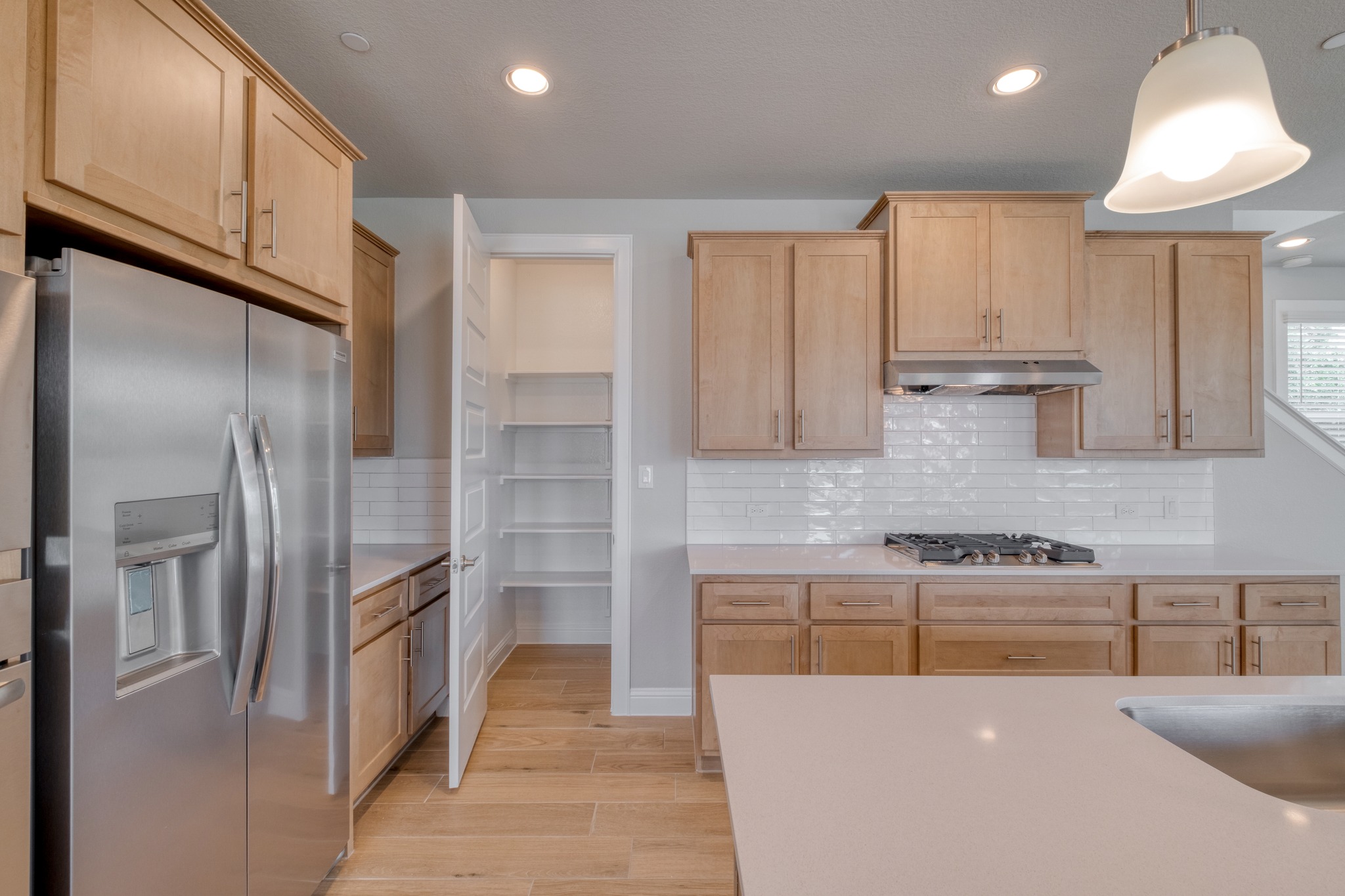 2605 Sam Bass Road, Unit 44 Round Rock, TX 78681 - Photo 13 of 26 An inviting kitchen with light wood cabinetry, sleek stainless steel appliances, and a convenient pantry.