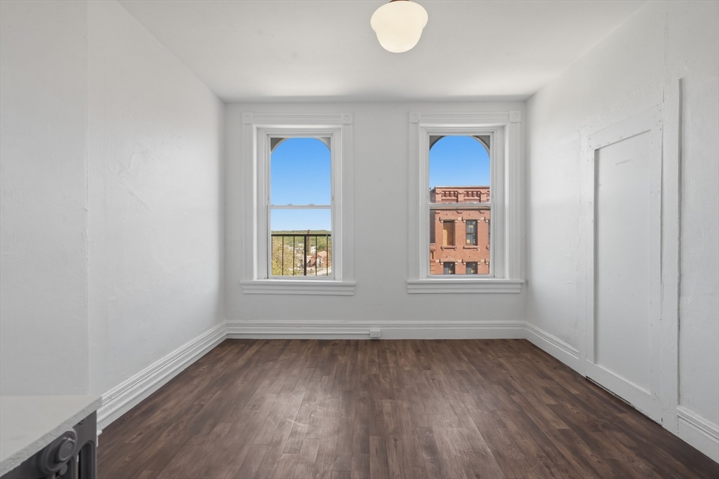 105 High Street, Unit 4P Holyoke, MA 01040 - Photo 9 of 11 an empty room with wooden floor and windows
