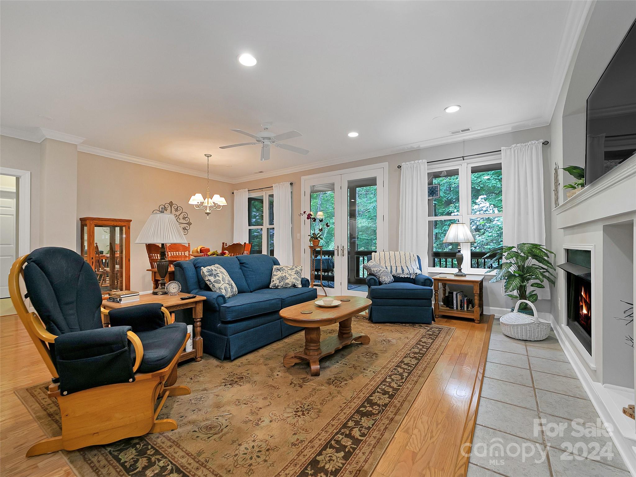 99 Ridgetop Circle, Unit 102 Brevard, NC 28712 - Photo 16 of 36 a living room with fireplace furniture and a large window
