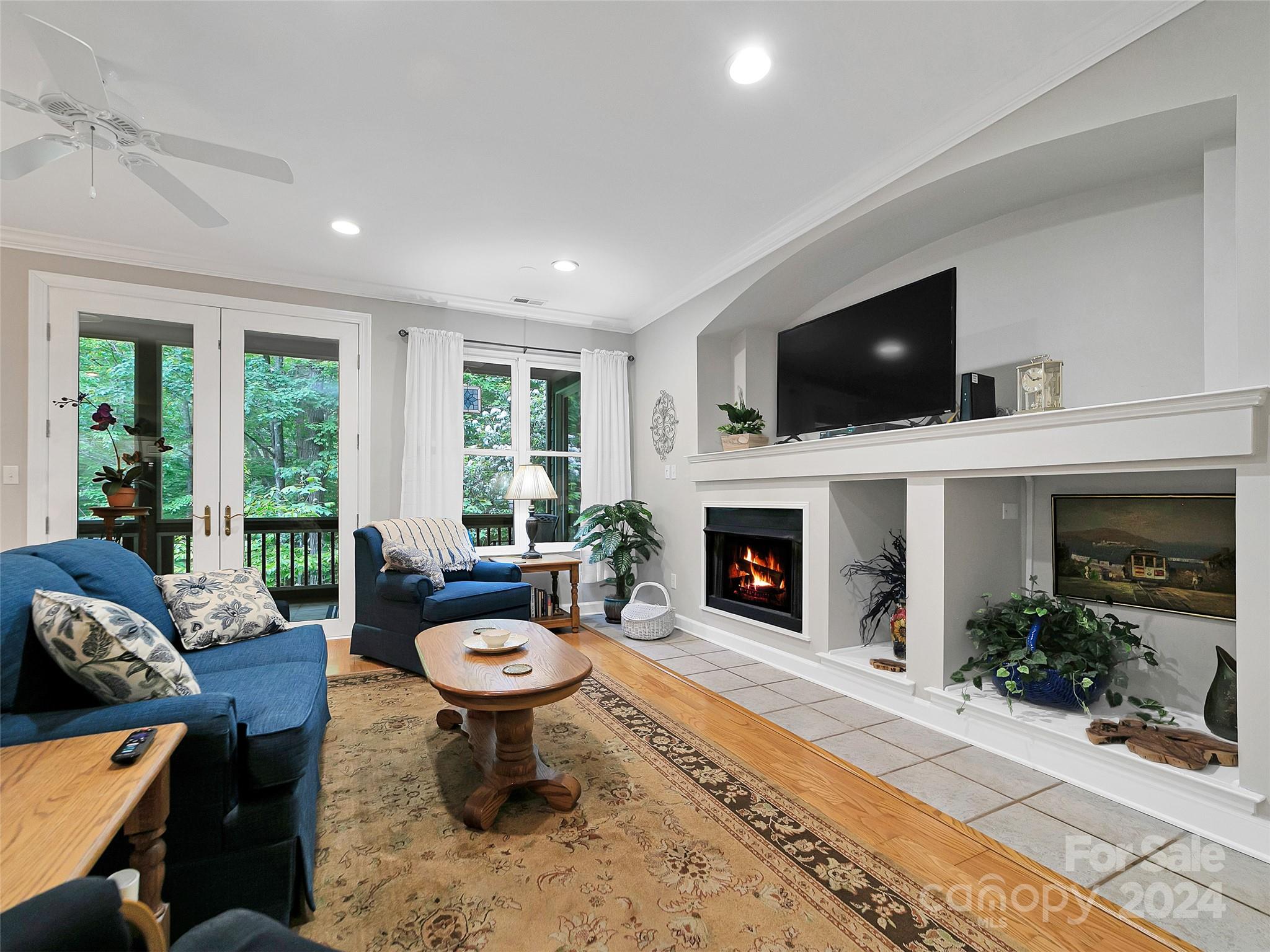 99 Ridgetop Circle, Unit 102 Brevard, NC 28712 - Photo 17 of 36 a living room with furniture a fireplace and a flat screen tv