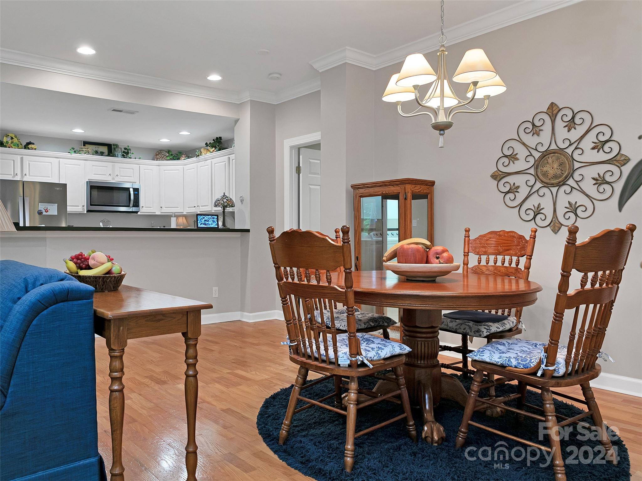 99 Ridgetop Circle, Unit 102 Brevard, NC 28712 - Photo 23 of 36 a view of a dining room with furniture and chandelier
