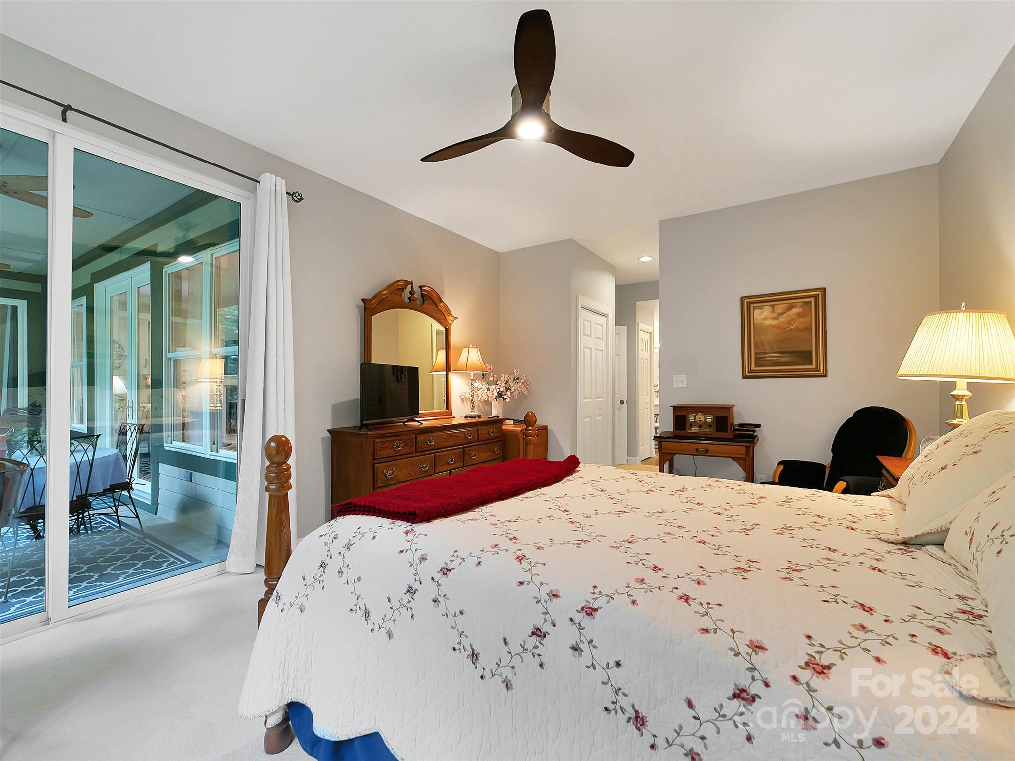 99 Ridgetop Circle, Unit 102 Brevard, NC 28712 - Photo 34 of 36 a bedroom with a bed and a large mirror next to a window