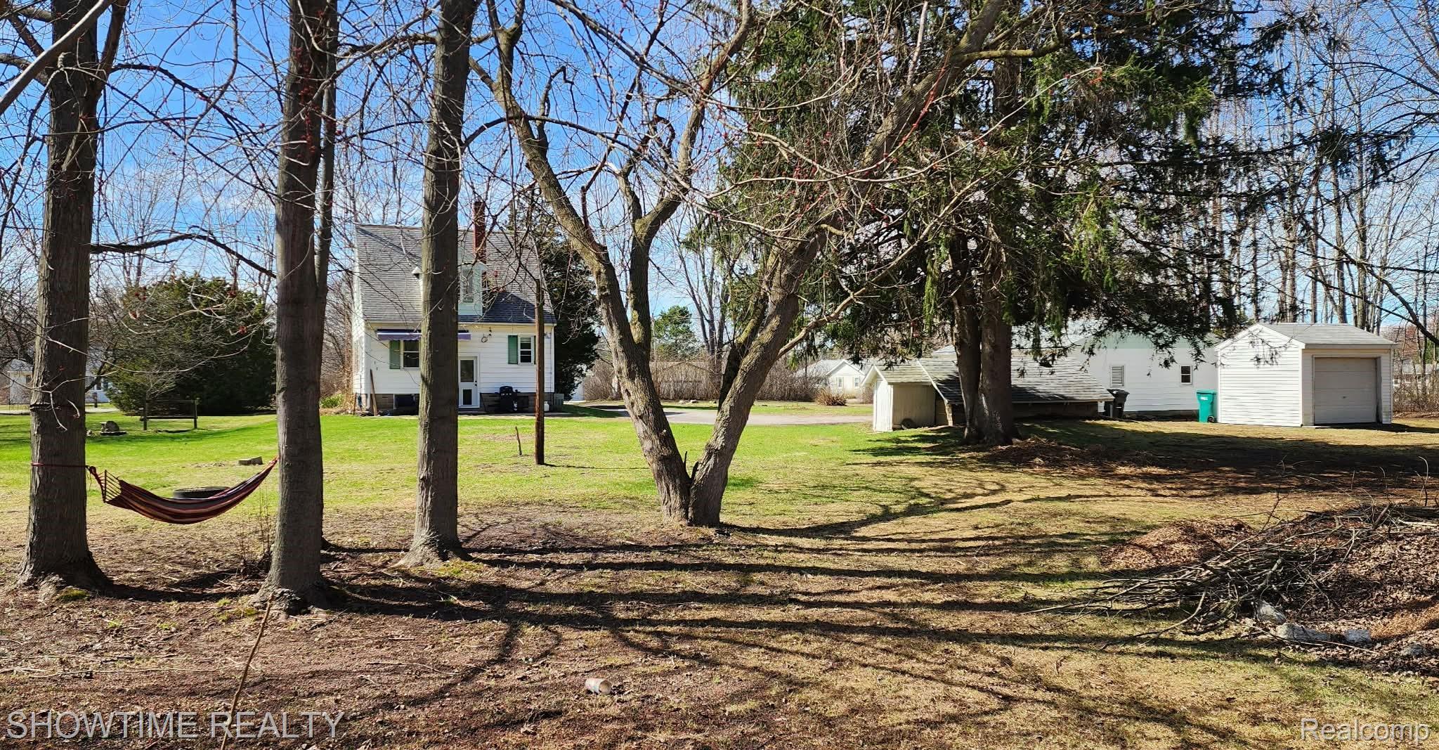 2970 Range Road Port Huron, MI 48060 - Photo 4 of 31 Expansive yard featuring mature trees, a detached garage, and a shed