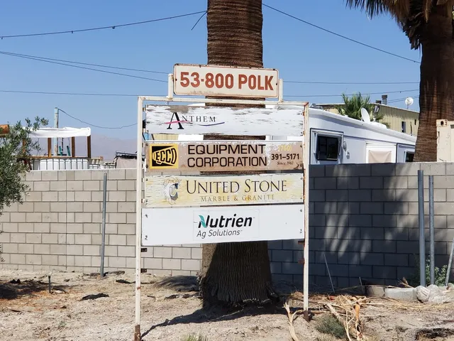 a view of a dry yard with wooden fence