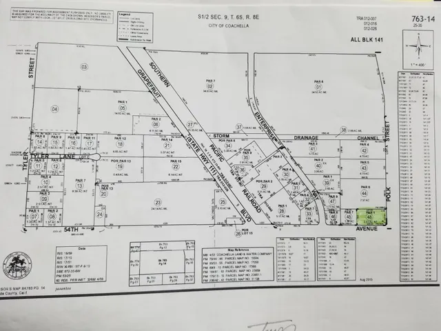 a view of a yard with tall buildings