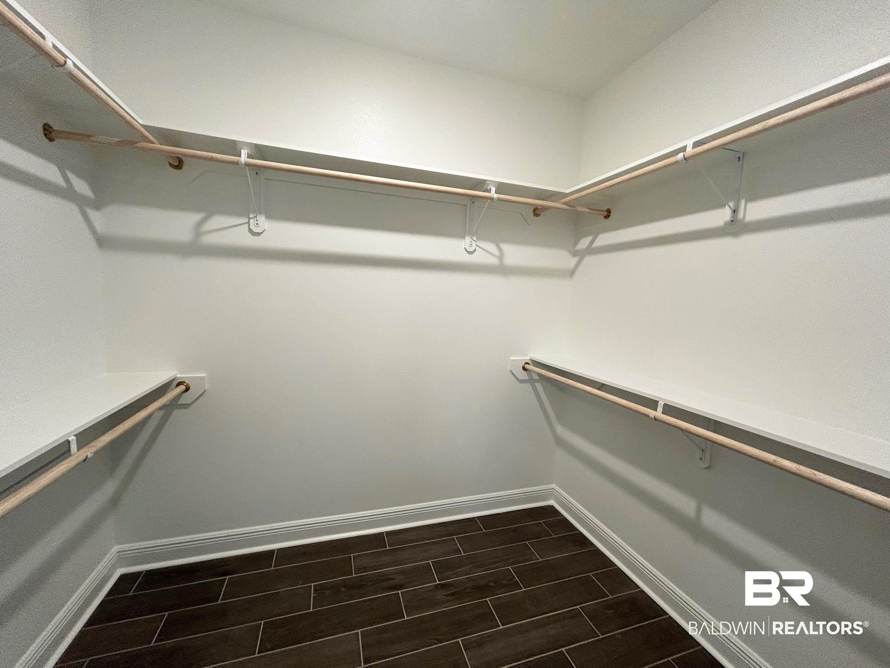 876 Sumter Loop Foley, AL 36535 - Photo 15 of 24 Walk in closet featuring dark wood-type flooring