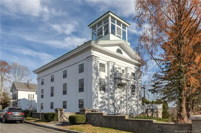 a front view of a residential apartment building with a yard