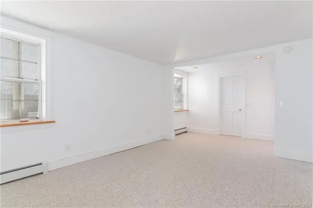 a view of an empty room with windows