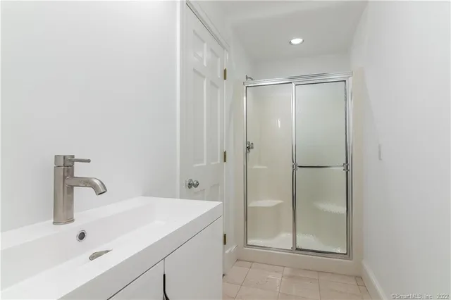 a bathroom with a toilet a sink a vanity and mirror