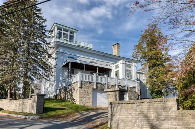 a view of a roof deck with furniture