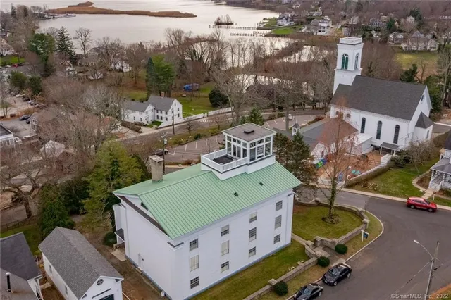 an aerial view of a house with garden space and street view