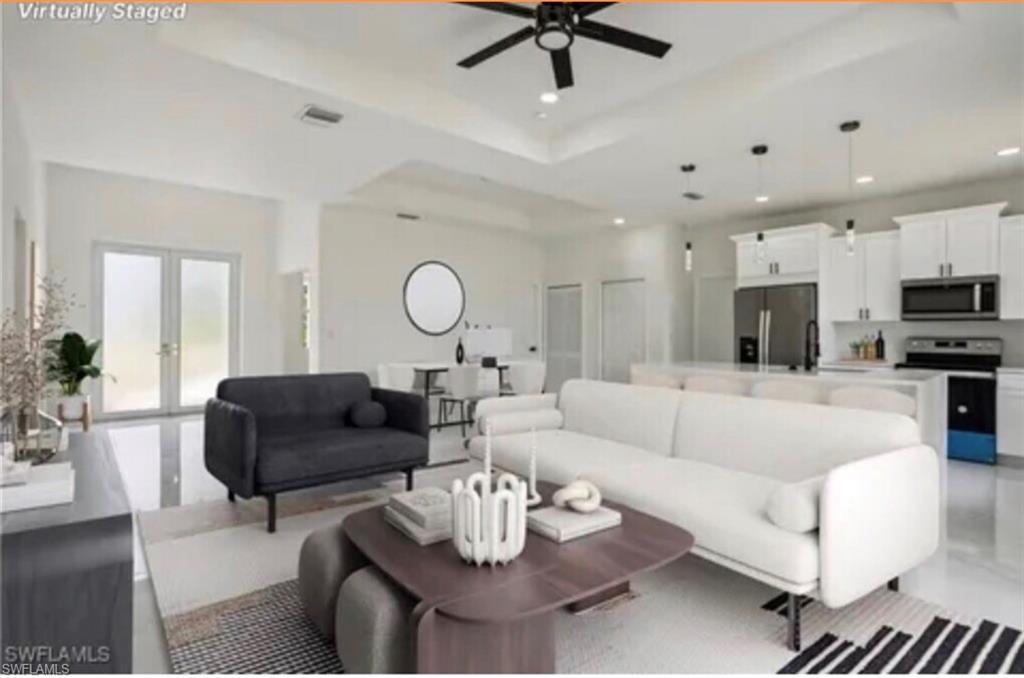 2512 9th Street Southwest Lehigh Acres, FL 33976 - Photo 2 of 10 a living room with furniture kitchen view and a wooden floor