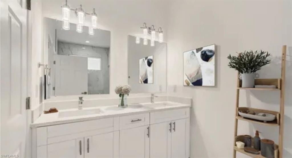 2512 9th Street Southwest Lehigh Acres, FL 33976 - Photo 8 of 10 a bathroom with a sink a potted plant and a mirror