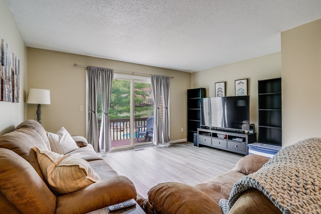 31 Hunters Run Place, Unit 31 Haverhill, MA 01832 - Photo 11 of 32 a bedroom with furniture and a flat screen tv