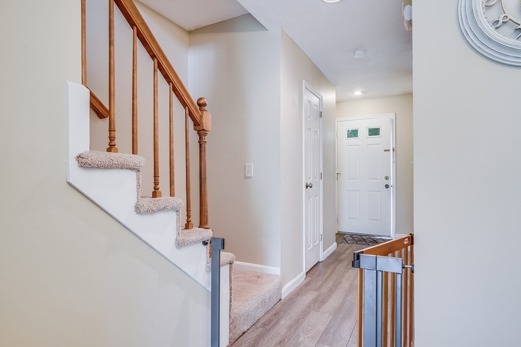 31 Hunters Run Place, Unit 31 Haverhill, MA 01832 - Photo 12 of 32 a view of a hallway with wooden floor and staircase