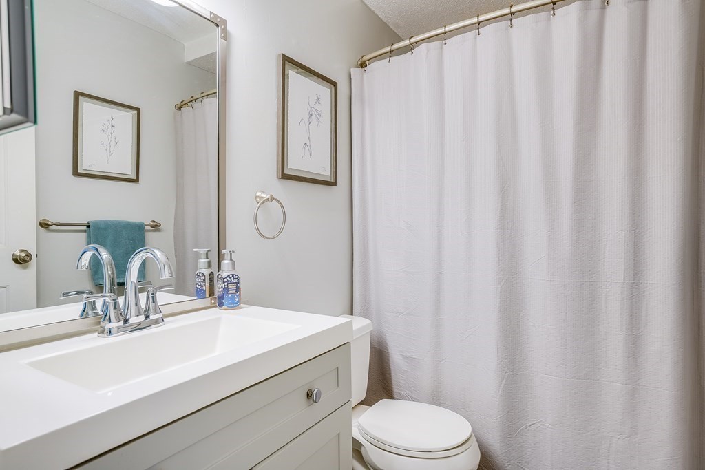31 Hunters Run Place, Unit 31 Haverhill, MA 01832 - Photo 16 of 32 a bathroom with a sink a toilet and shower