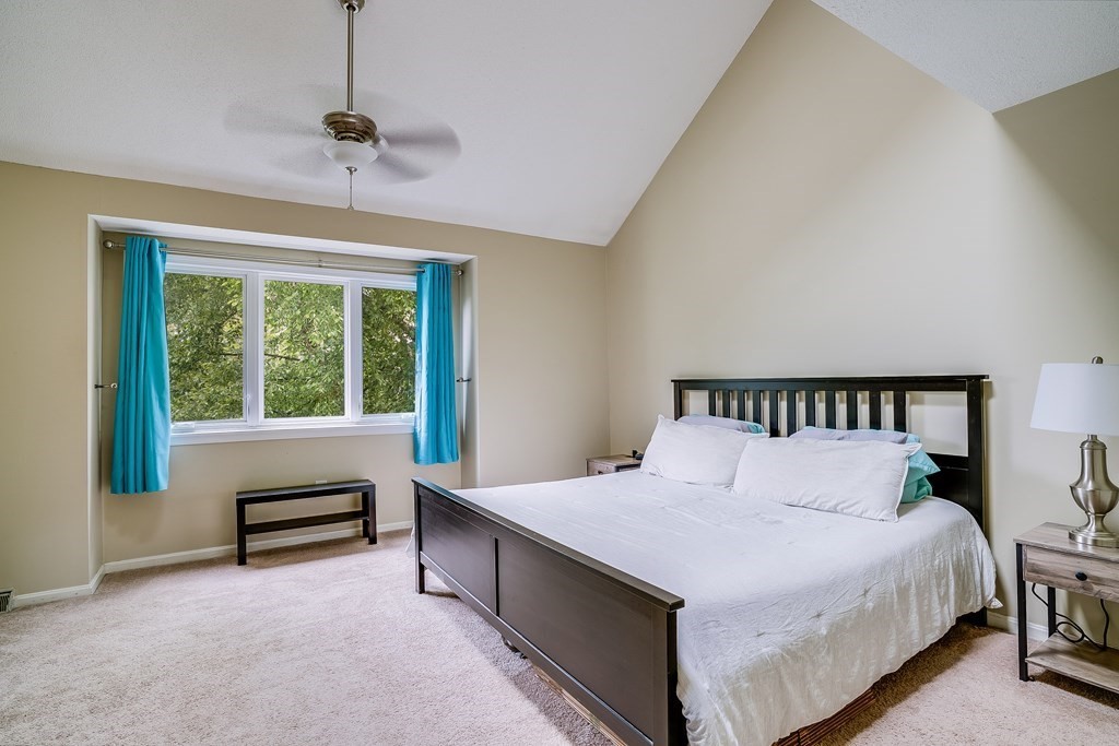 31 Hunters Run Place, Unit 31 Haverhill, MA 01832 - Photo 19 of 32 a large bed sitting in a bedroom next to a window