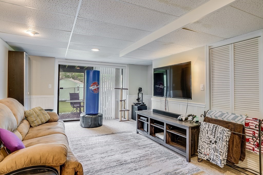 31 Hunters Run Place, Unit 31 Haverhill, MA 01832 - Photo 23 of 32 a living room with furniture windows and a flat screen tv