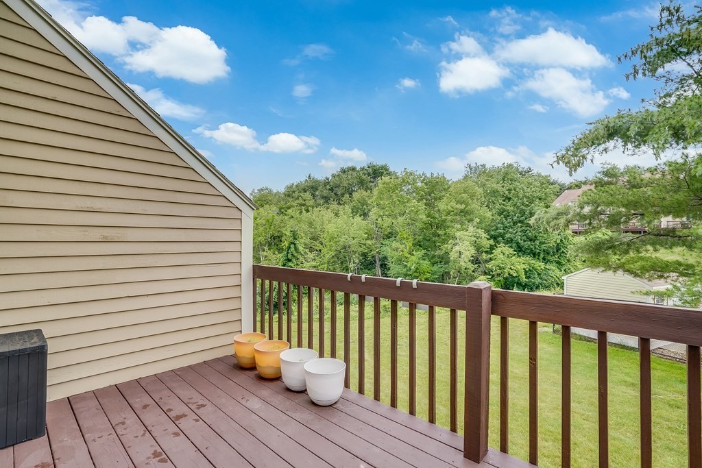31 Hunters Run Place, Unit 31 Haverhill, MA 01832 - Photo 24 of 32 a balcony with wooden floor and fence