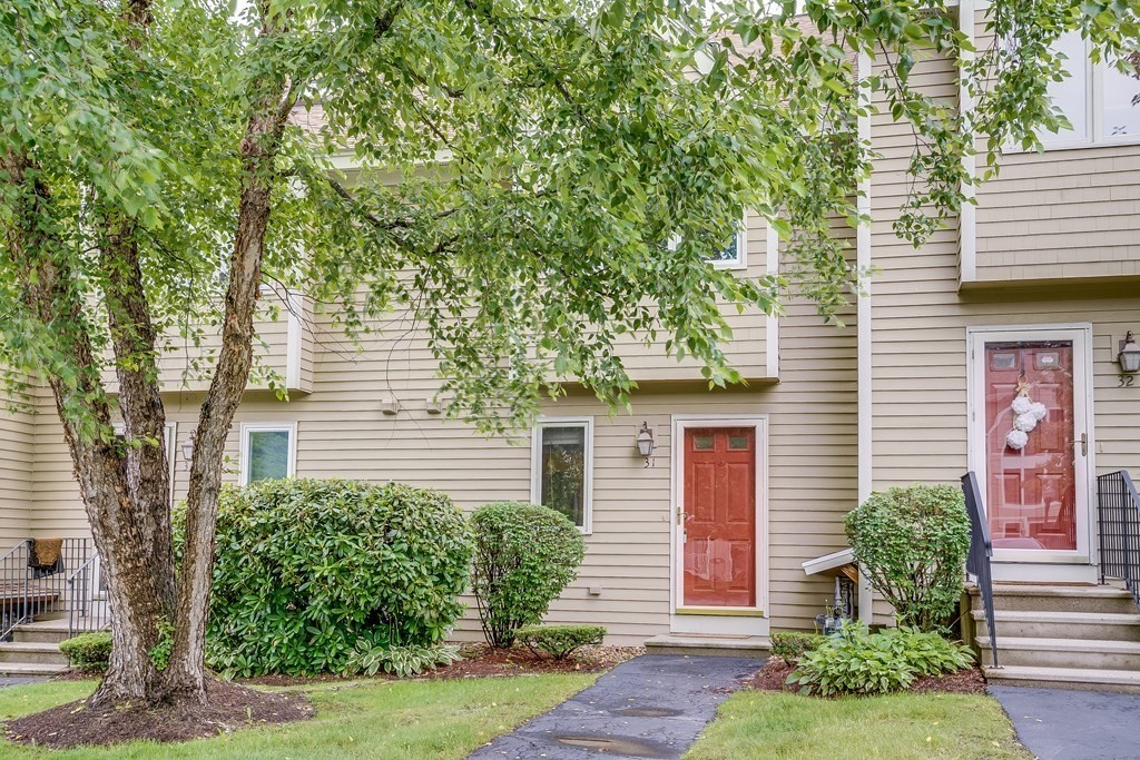 31 Hunters Run Place, Unit 31 Haverhill, MA 01832 - Photo 28 of 32 a front view of a house with a yard