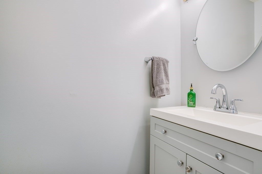 31 Hunters Run Place, Unit 31 Haverhill, MA 01832 - Photo 7 of 32 a bathroom with a sink vanity and a mirror