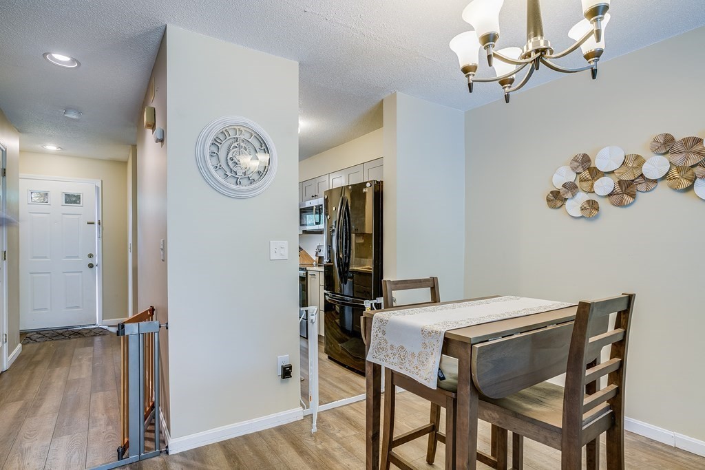 31 Hunters Run Place, Unit 31 Haverhill, MA 01832 - Photo 8 of 32 a view of a dining room with furniture and a chandelier