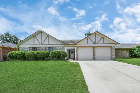 a front view of a house with yard and green space