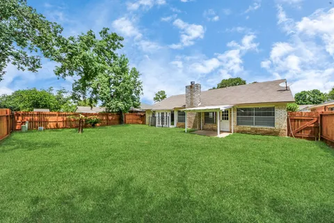 a view of a house with backyard and garden