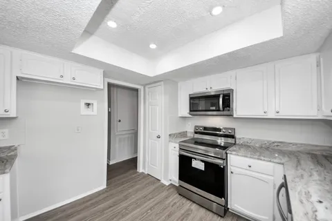 a kitchen with granite countertop a stove and a sink