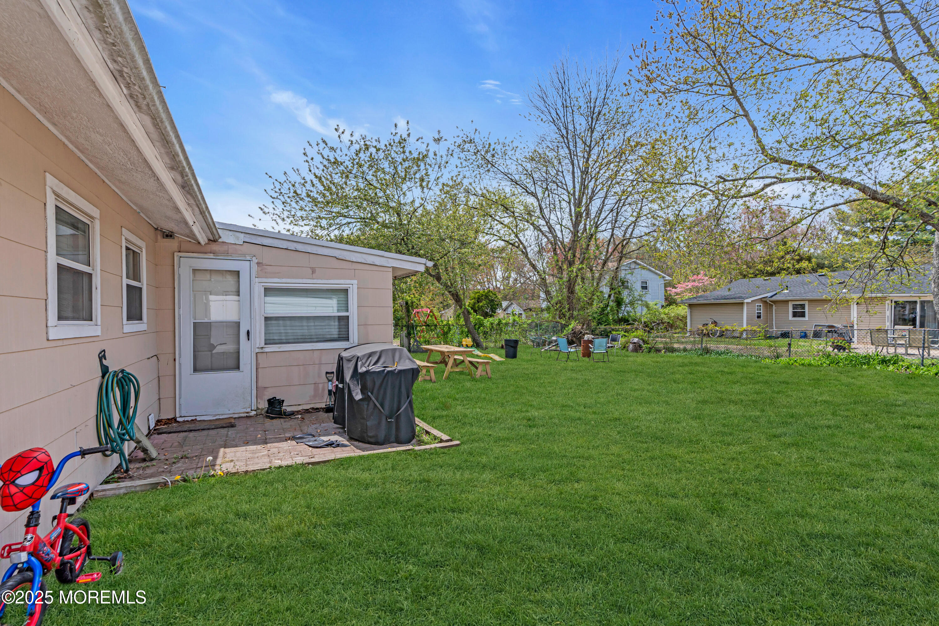 111 3rd Street Barnegat, NJ 08005 - Photo 22 of 22 a view of a backyard with table and chairs potted plants and large tree