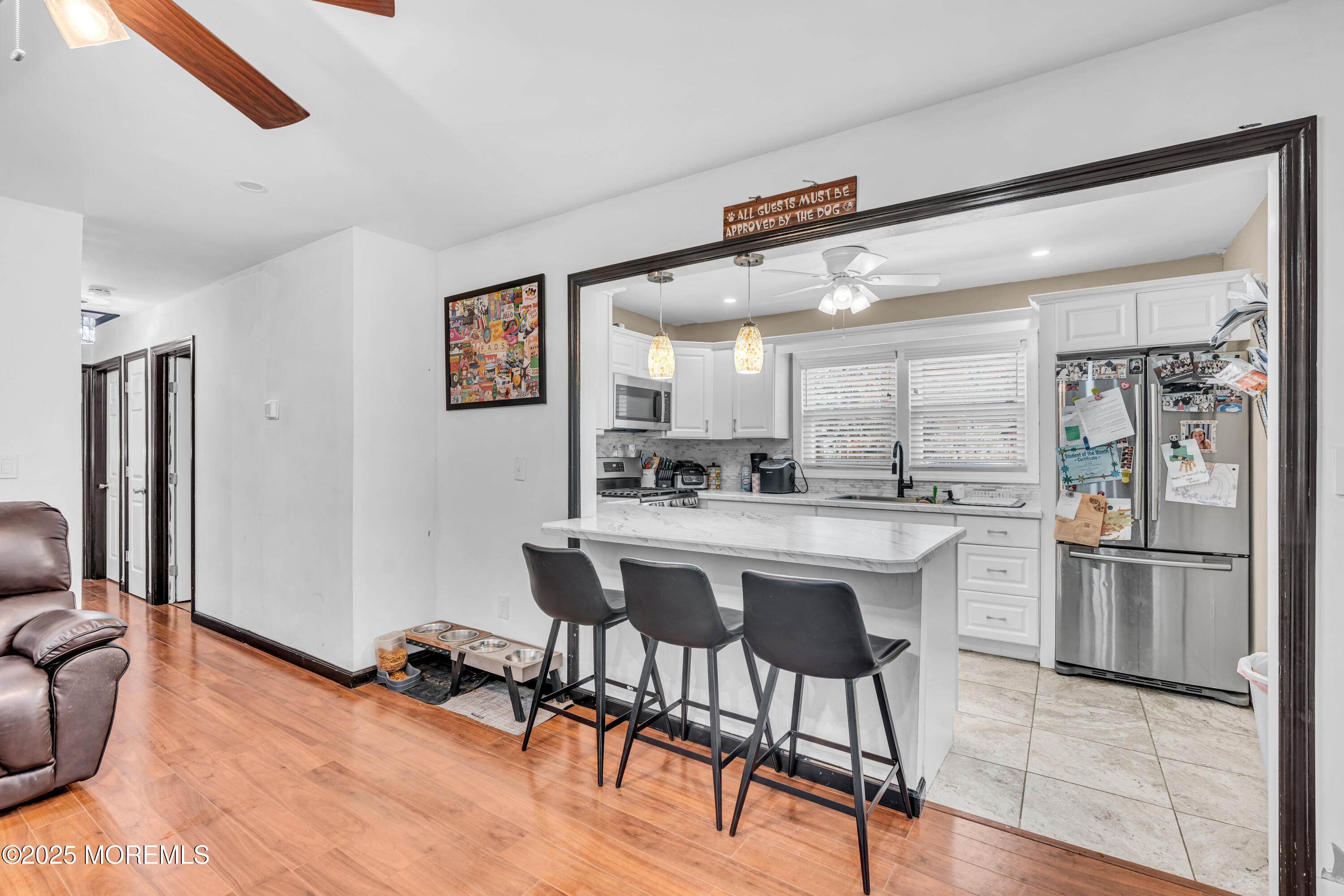 111 3rd Street Barnegat, NJ 08005 - Photo 8 of 22 a kitchen with stainless steel appliances kitchen island a table and chairs in it