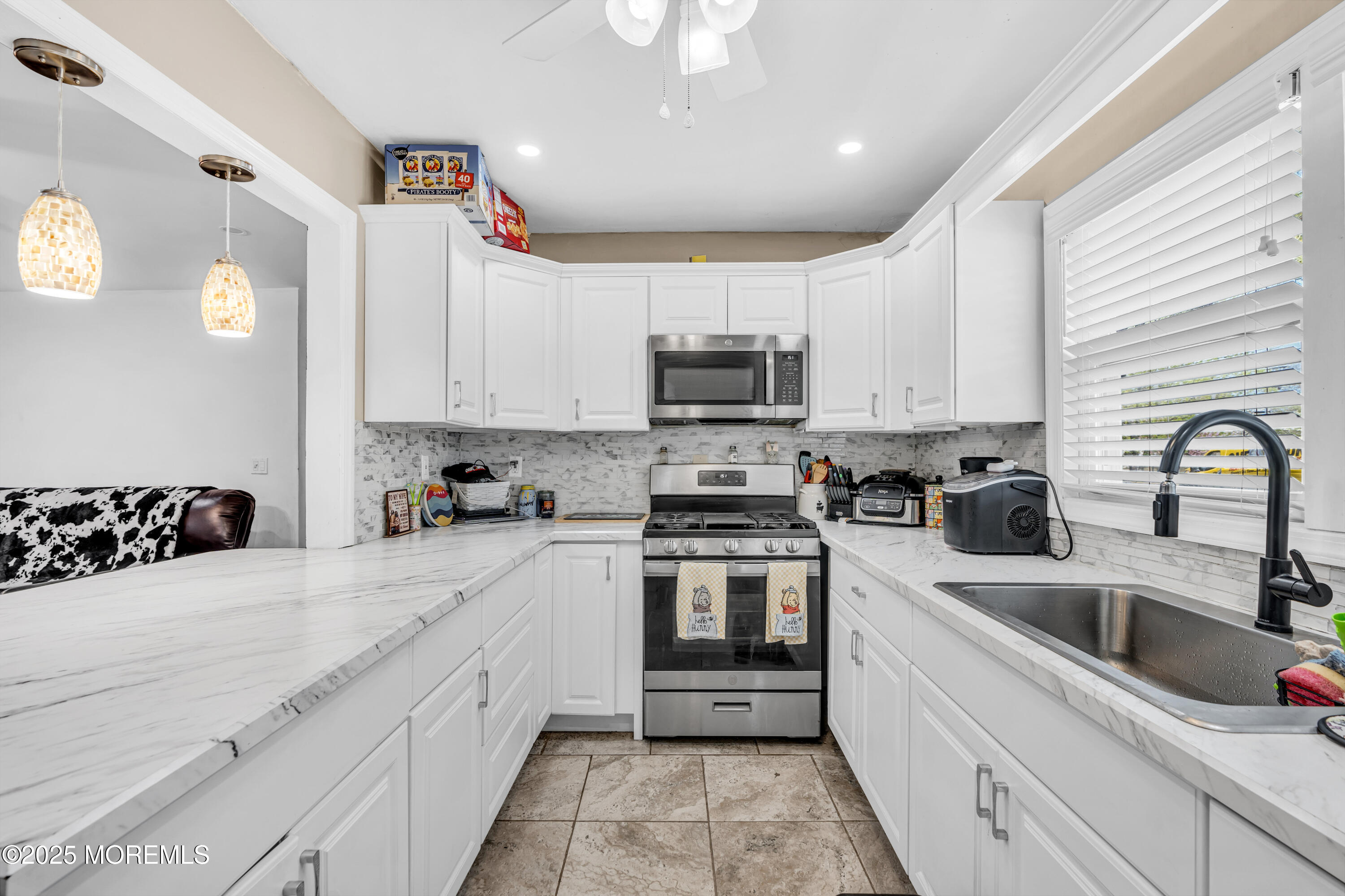 111 3rd Street Barnegat, NJ 08005 - Photo 9 of 22 a kitchen with a sink white cabinets and white appliances