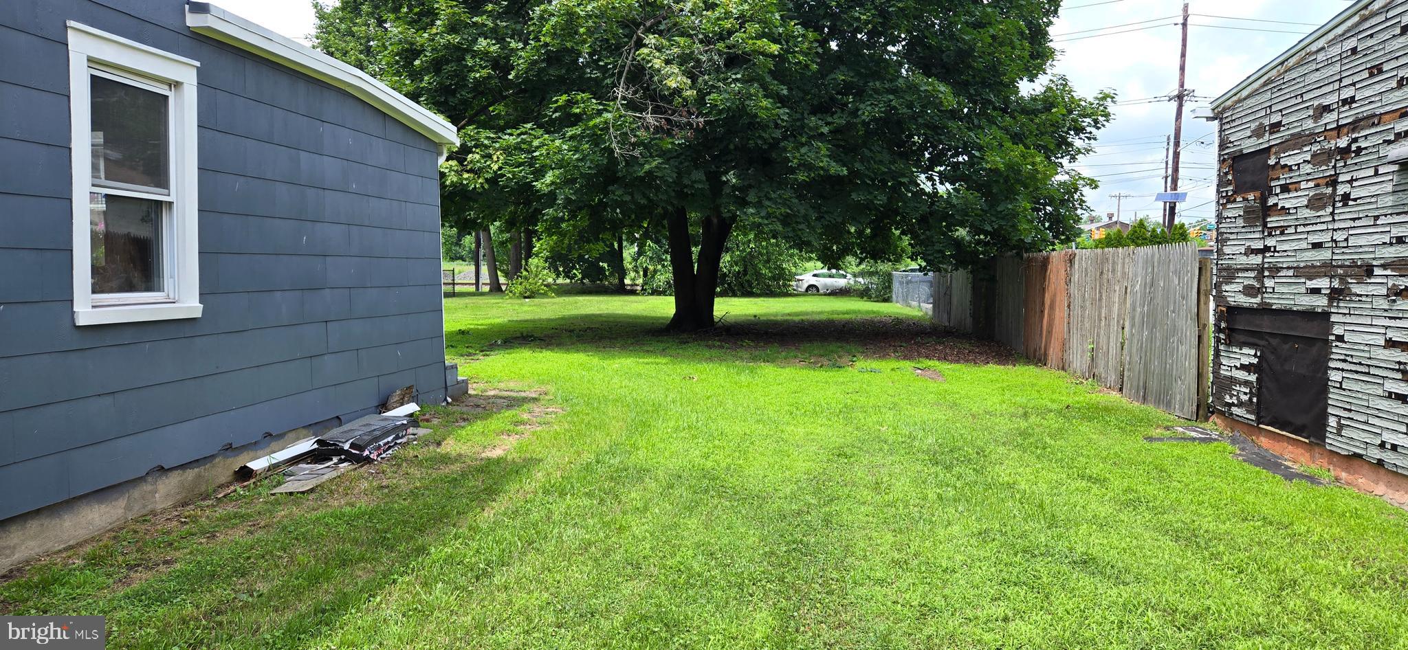 845 Bordentown Road Burlington, NJ 08016 - Photo 7 of 17 a view of a backyard with large trees and wooden fence