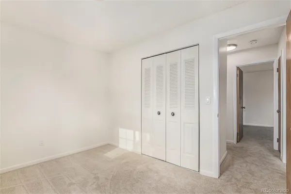 an empty room with closet area