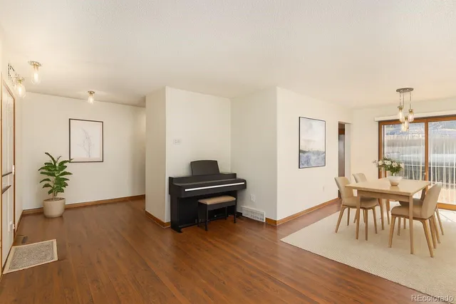 a view of a livingroom with furniture window and wooden floor